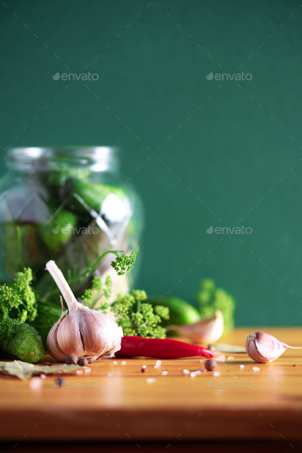 Ingredients, spices and herbs for canning cucumbers on green background. Copy space. Dill flowers - Stock Photo - Images