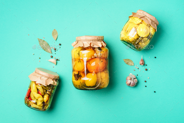 ?ucumber, squash and tomatoes pickling and canning into glass jars. Ingredients for vegetables - Stock Photo - Images
