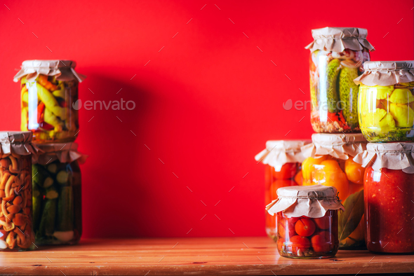 ?ucumber, squash and tomatoes pickling and canning into glass jars. Ingredients for vegetables - Stock Photo - Images