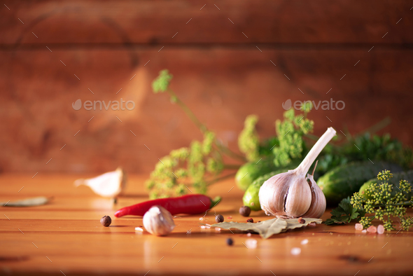 Pickling cucumbers in cans. Ingredients for marinated gherkins, glass jar, garlic, dill, salt - Stock Photo - Images