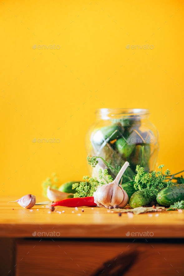 Ingredients, spices and herbs for canning cucumbers on yellow background. Copy space. Dill flowers - Stock Photo - Images