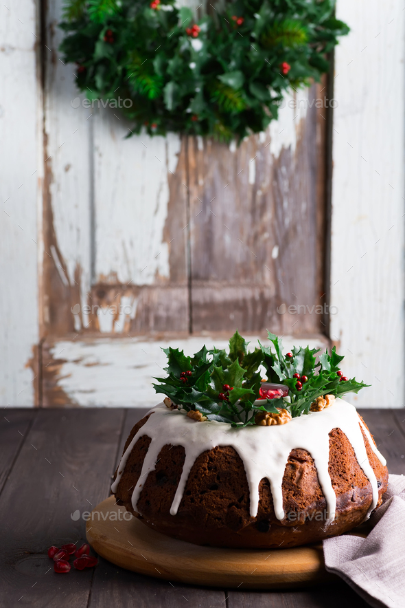 Christmas homebaked chocolate cake decorated with white icing and pomegranate kernels against the - Stock Photo - Images