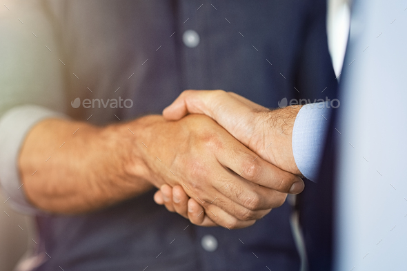 Close up of businessmen shaking hands - Stock Photo - Images