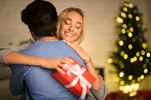 Happy wife embracing man, being thankful for present