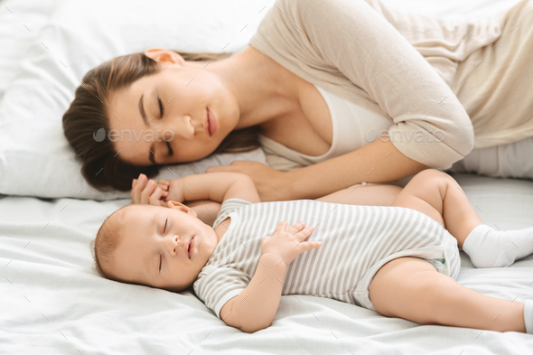 Adorable Infant Child Sleeping With His Mom In Bedroom Stock Photo By