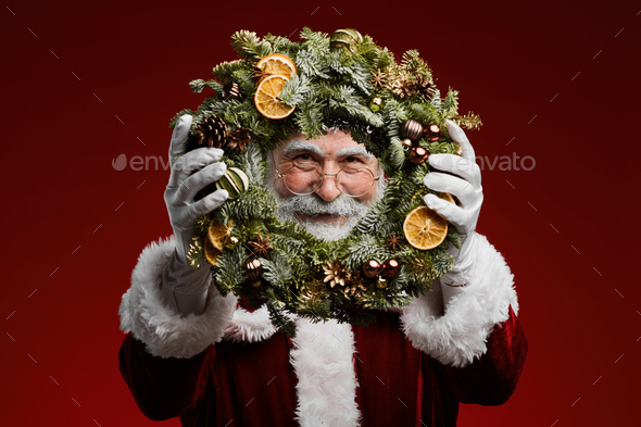 Santa Holding Christmas Wreath - Stock Photo - Images