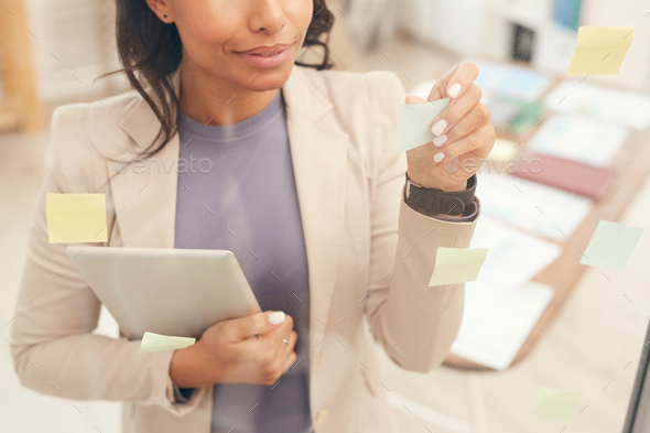Businesswoman Planning Project by Glass Wall Background - Stock Photo - Images