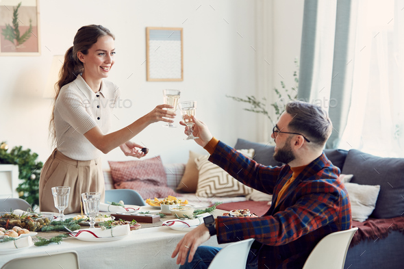 Elegant Couple Toasting at Christmas Party - Stock Photo - Images