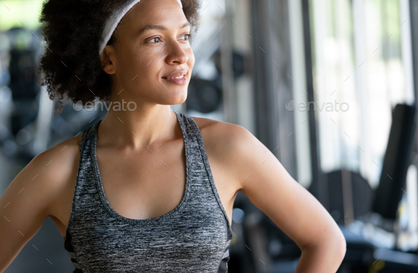 Portrait of young african fitness woman in gym Stock Photo by nd3000