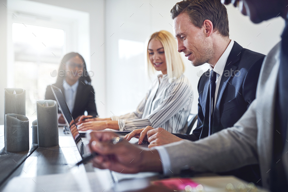 Diverse businesspeople having a meeting together in an office - Stock Photo - Images