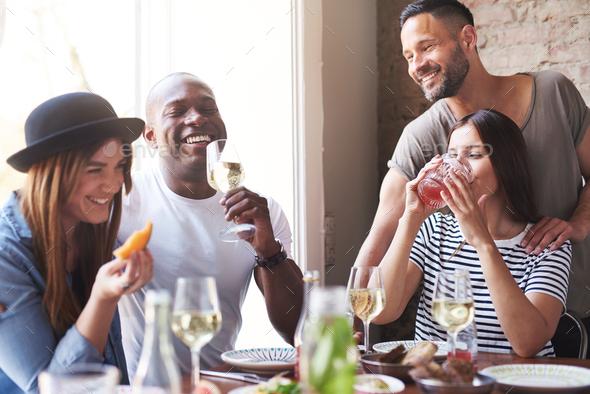 Group of adults celebrating with wine at lunch - Stock Photo - Images