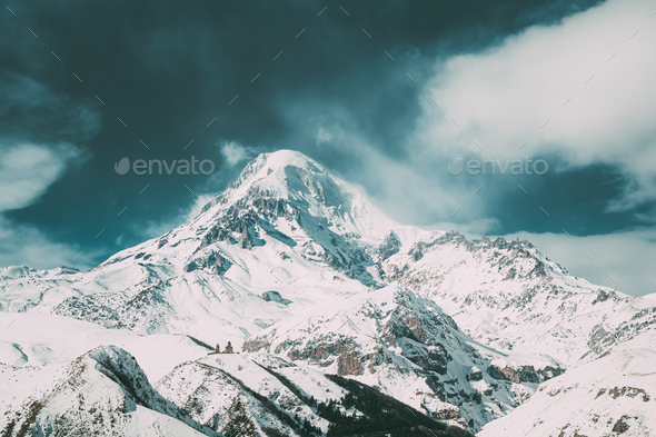 Stepantsminda, Gergeti, Georgia. Peak Of Mount Kazbek Covered With Snow. - Stock Photo - Images