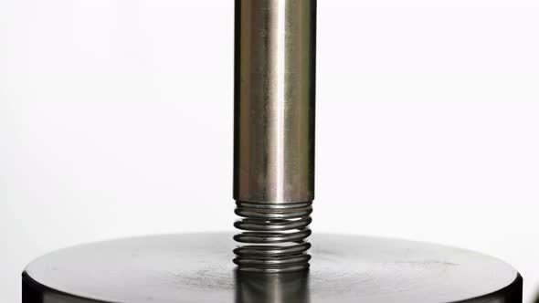 Test of Reliability of a Spring, Compression and Decompression By a Hydraulic Press, Close-up alt