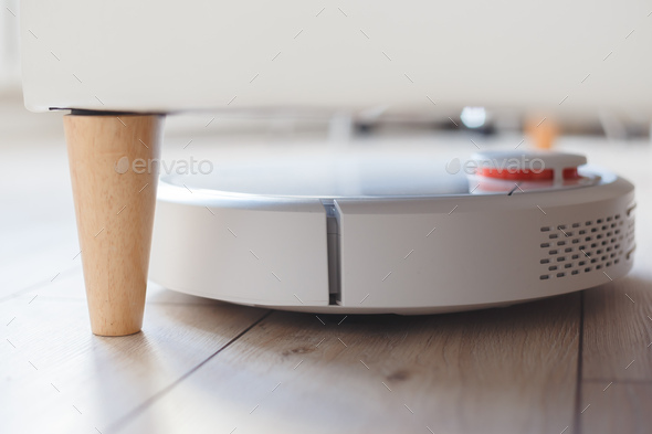 Robot vacuum cleaner vacuuming under the bed