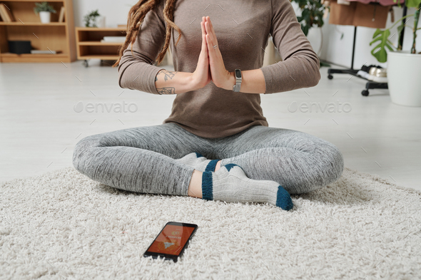A woman sitting and meditating with her legs crossed in a yoga pose Stock  Vector | Adobe Stock