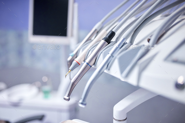Modern metallic dentist tools and burnishers on a dentist chair - Stock Photo - Images