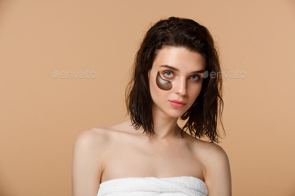 Woman applying under eye moisturising patches - Stock Photo - Images