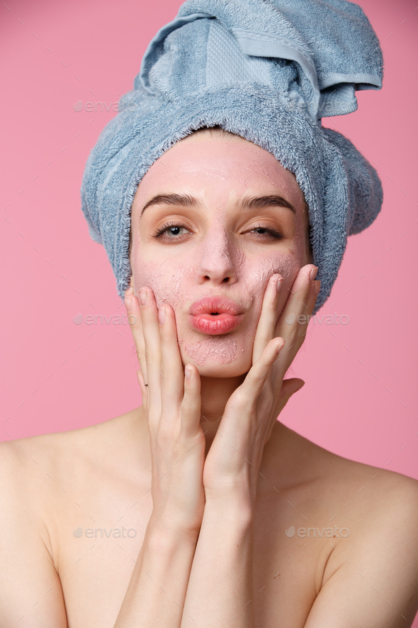 Beauty treatment - woman applying clay face mask - Stock Photo - Images