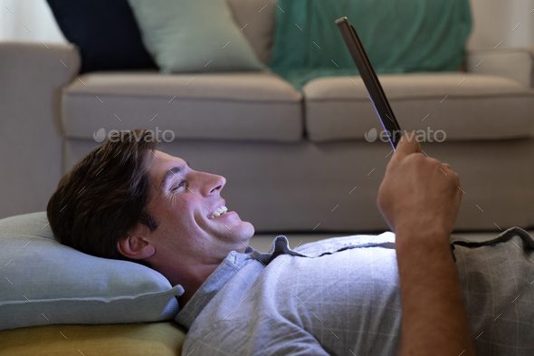 Young couple relaxing at home using a smartphone together