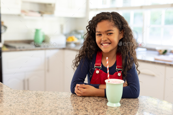 Girl in a kitchen at Christmas time - Stock Photo - Images