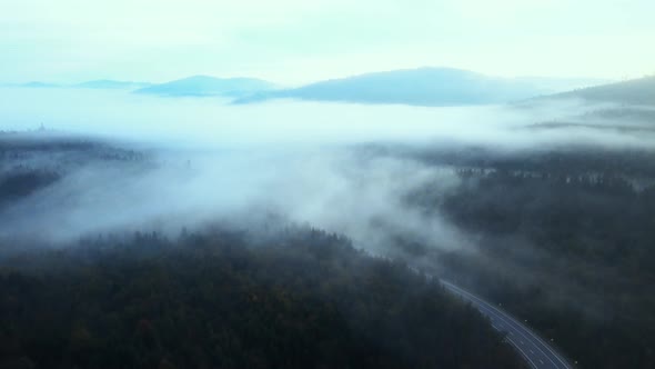 Huge mountains in morning fog alt