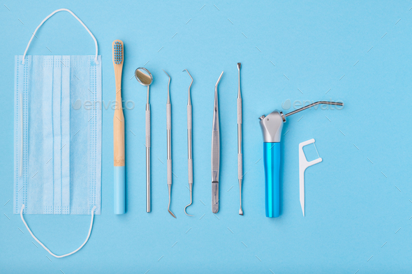 Dentist tools over blue background top view Stock Photo by haveseen