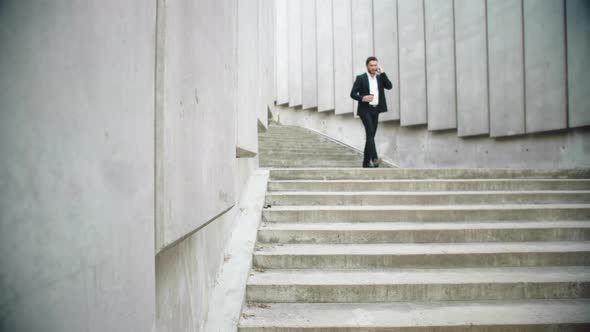 Business Man Running for Work on Street. Male Entrepreneur Calling on Smartphone alt