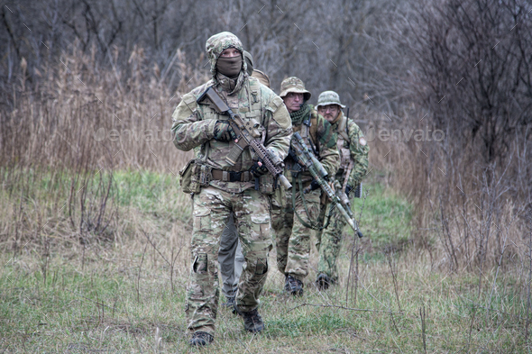 Army commandos tactical group on march in woods - Stock Photo - Images