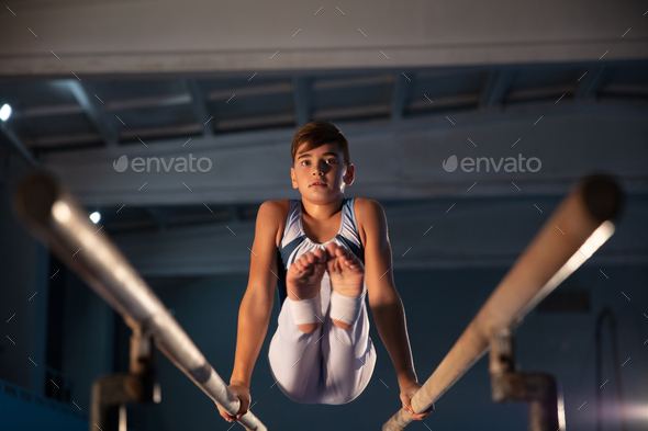 Little male gymnast training in gym, flexible and active - Stock Photo - Images