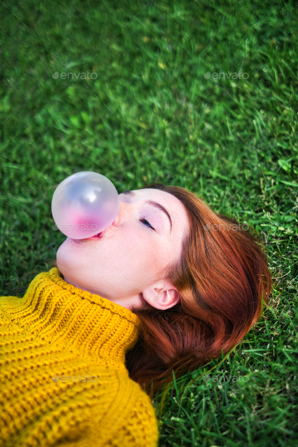 Young Woman Chewing Gum And Making Big Balloon - Stock Photo - Images