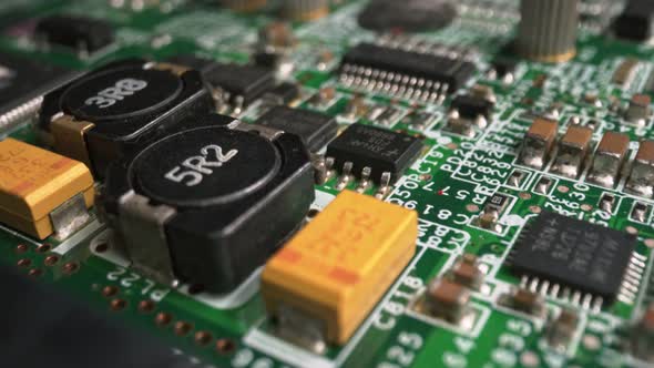 Extreme close-up of green Printed Circuit Board Electronics shot with dolly alt