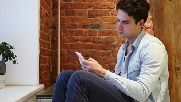 Man Browsing Online on Smartphone Internet Searching alt
