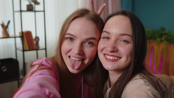 Two Women Friends Siblings Bloggers at Home Laughing Spend Leisure Time Taking Selfie Pictures alt
