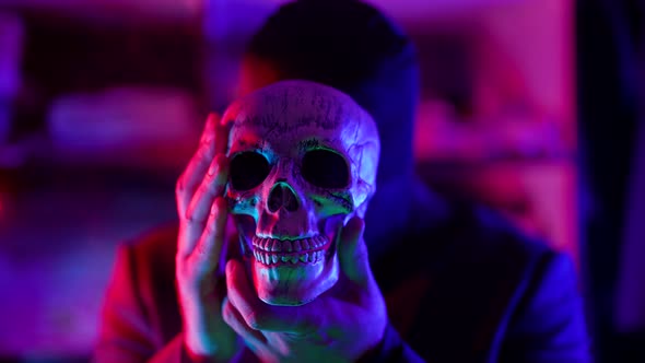 Serial Killer and Maniac with Human Skull in Hands Gloomy Man with Black Mask on Head alt