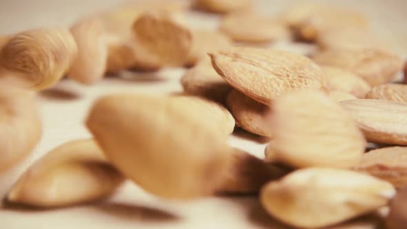 Slow Apricot Pits Fall on the Table Close-up