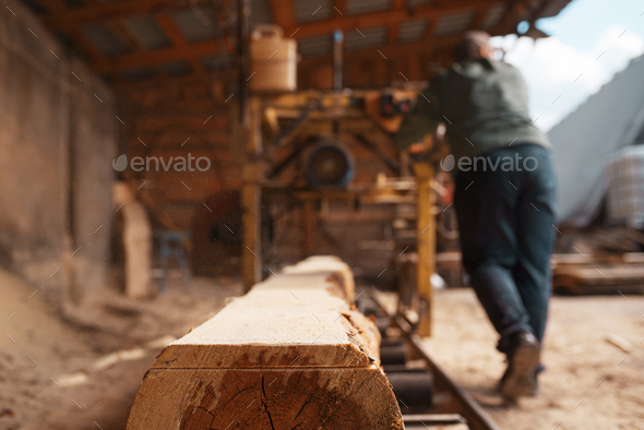 Joiner works on woodworking machine, lumbering - Stock Photo - Images