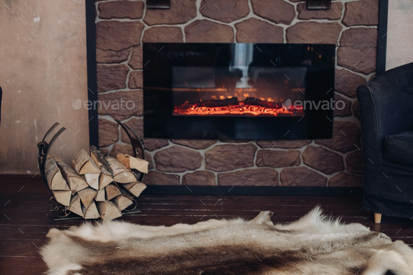 Cozy Room With Fireplace Fur Skin And Pile Of Woods Stock Photo