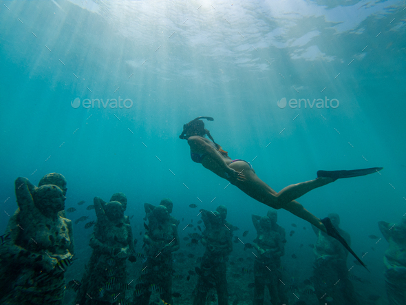 Freediving Girl swims over Underwater sculptures gili Meno, Southeast Asia