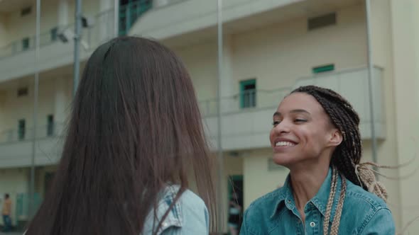 After Long Separation Two People Frends Mixed Race Go to Meet Each Other Hugging Jump for Happiness alt