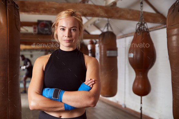 Portrait Of Female Boxer With Protective Wraps On Hands Training In Gym