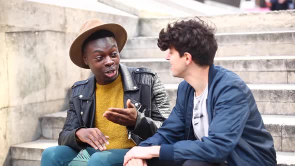 Multiracial male friends meeting in London, talking and having fun together