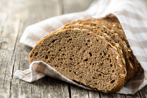 Sliced whole grain bread with oat flakes. Wholemeal bread. Stock ...