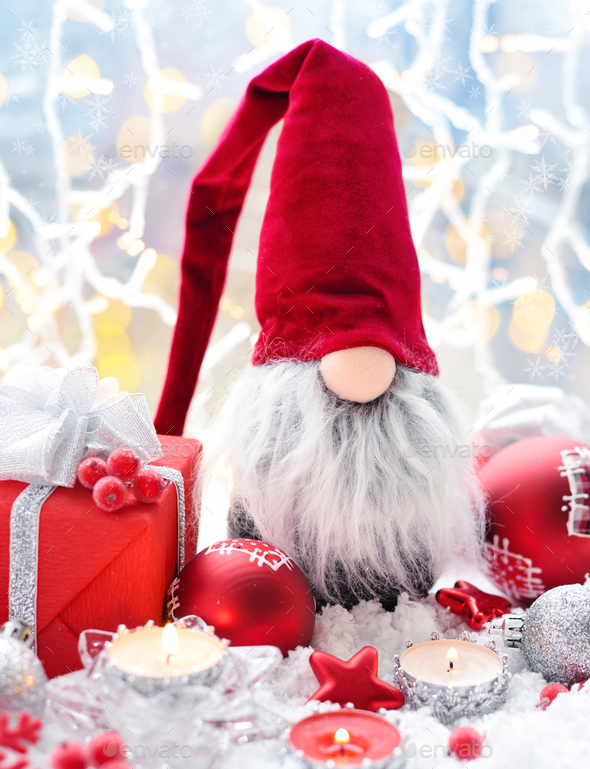 Christmas composition with the gnome, candles, gifts and festive decorations - Stock Photo - Images