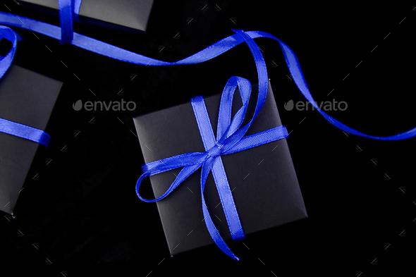 Luxury black gift boxes with blue ribbon - Stock Photo - Images