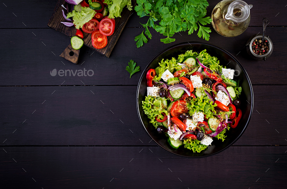 Greek salad with cucumber, tomato, sweet pepper, lettuce, red onion, feta cheese and olives. - Stock Photo - Images