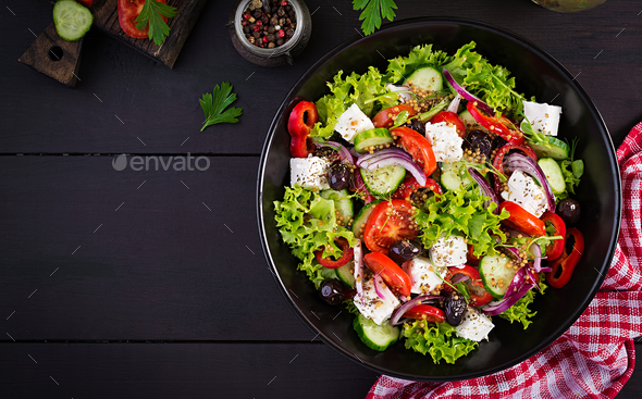 Greek salad with cucumber, tomato, sweet pepper, lettuce, red onion, feta cheese - Stock Photo - Images
