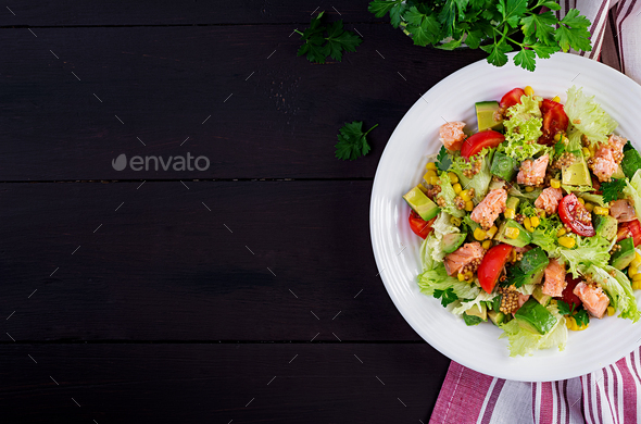 Salad with grilled salmon, lettuce, avocado, tomatoes and corn - Stock Photo - Images