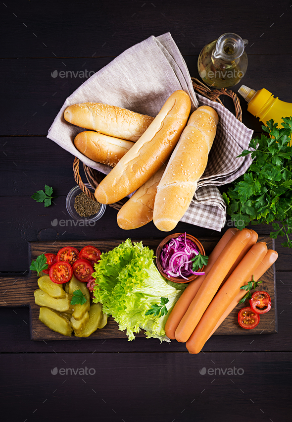 Ingredients for hot dog with sausage, pickled cucumber, tomatoes, red onions - Stock Photo - Images