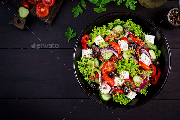 Healthy food. Greek salad with cucumber, tomato, sweet pepper, lettuce, red onion - Stock Photo - Images