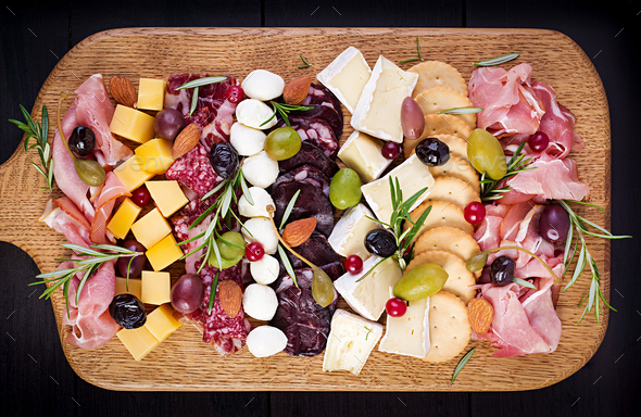 Antipasto platter with ham, prosciutto, salami, cheese, crackers and olives - Stock Photo - Images